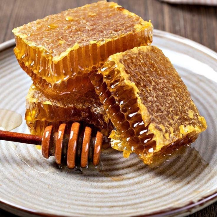 Raw natural honeycomb dripping with pure honey
